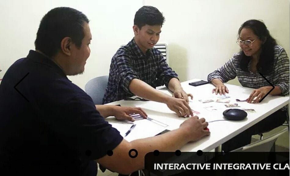 TELC learners and teacher working together in an interactive English class